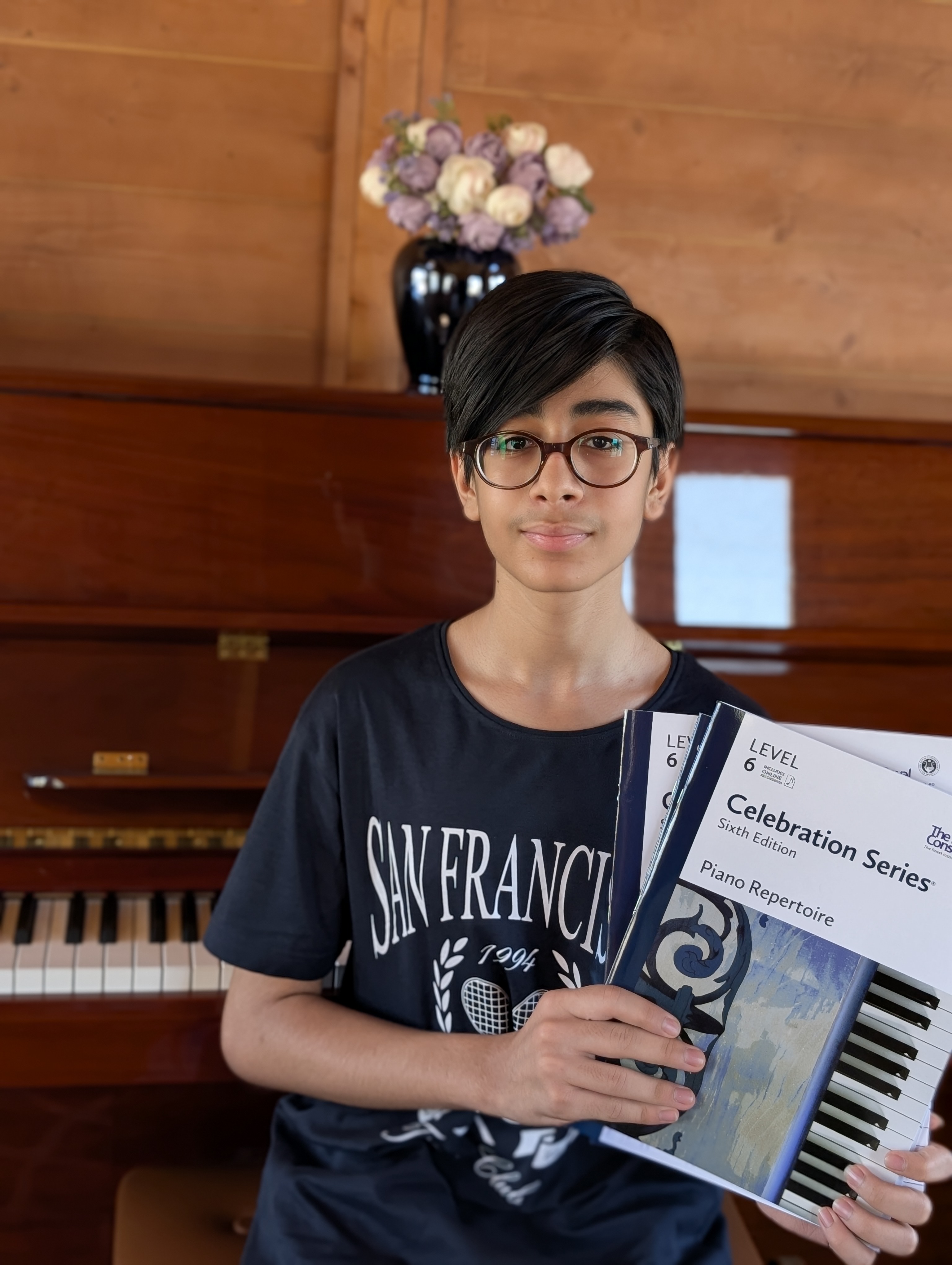 Student holding RCM Celebration Series Level 6 Piano Repertoire